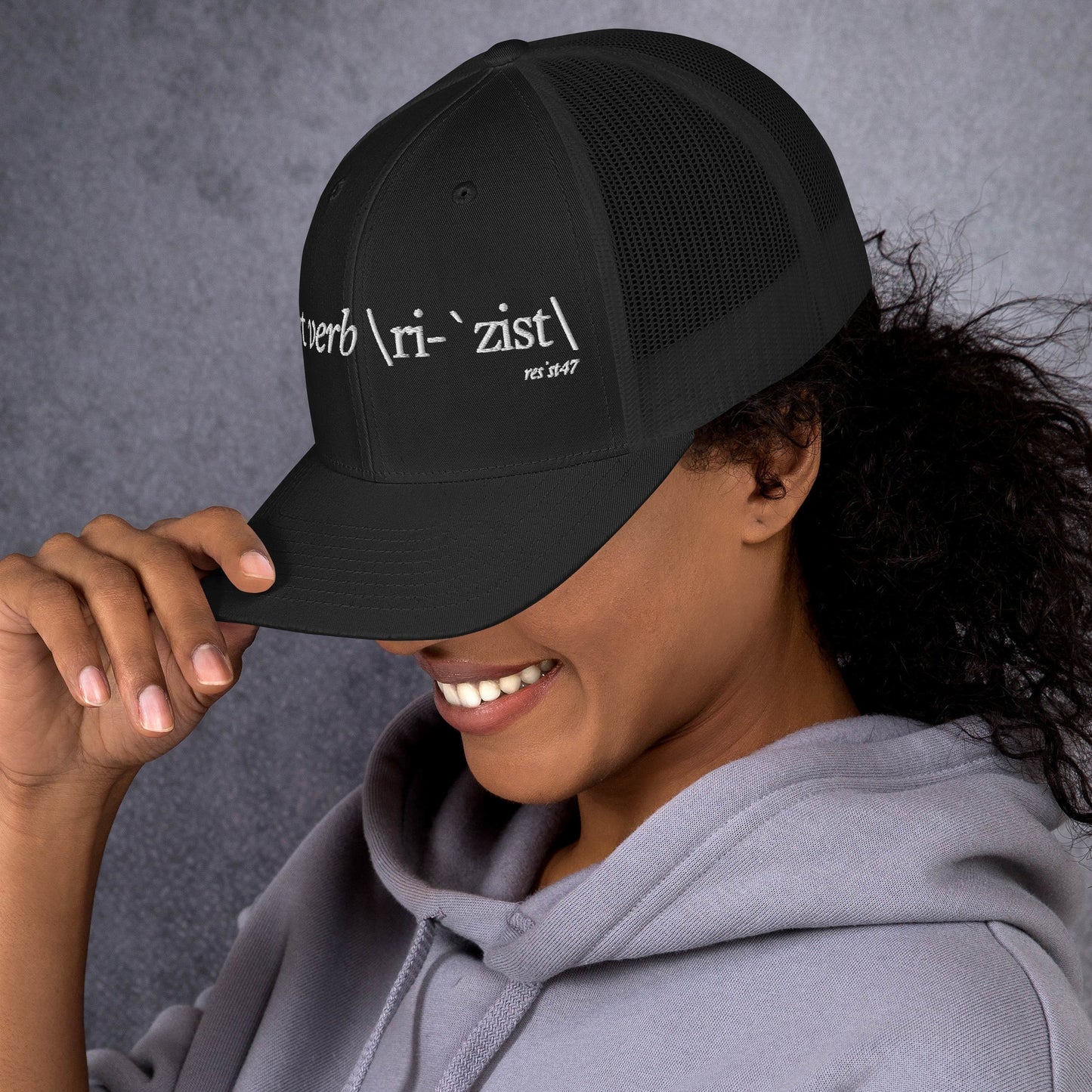 Black/ White cap with “Define Resist - Baseball” graphic, front view