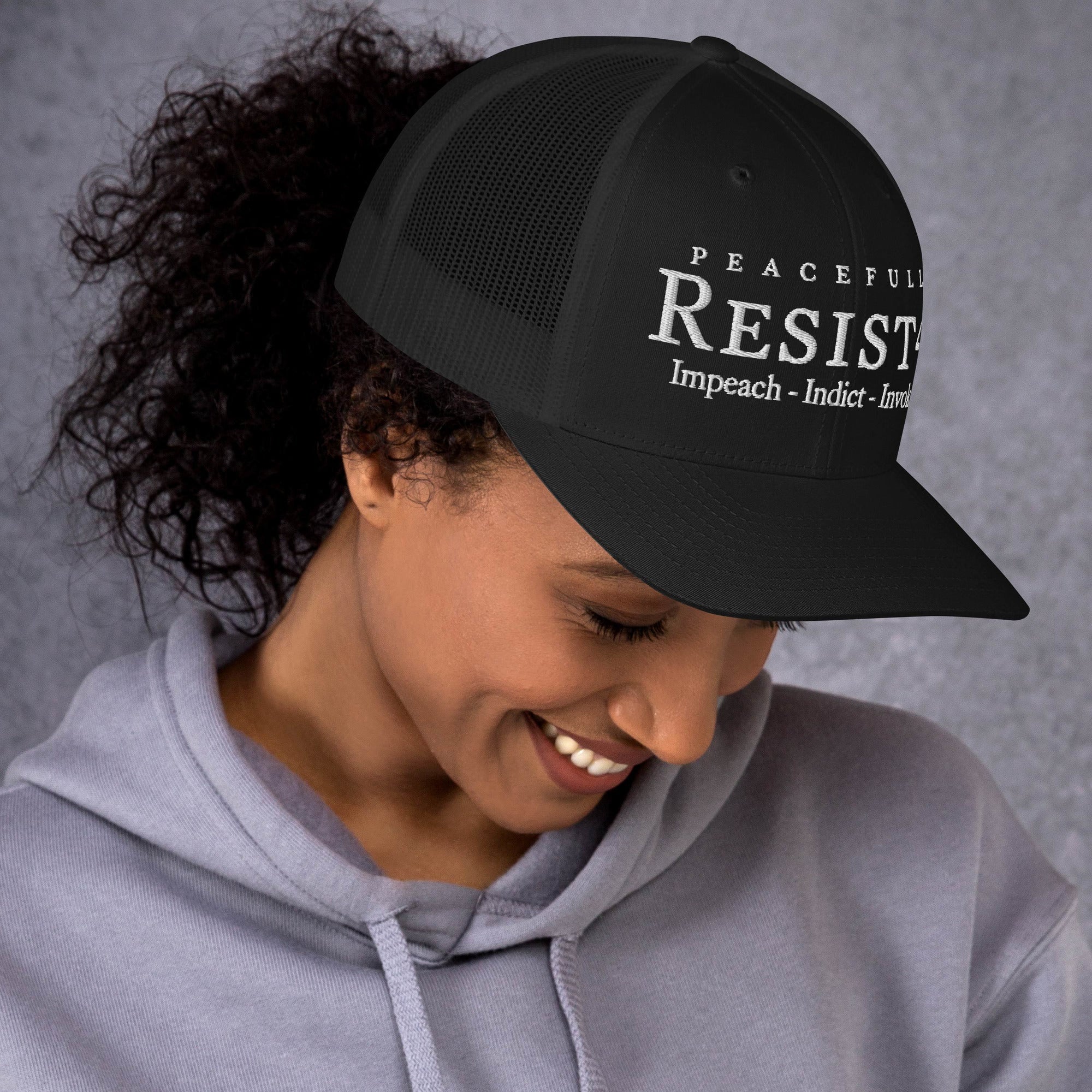 Black/ White cap with “Resist47 Protest” graphic, front view